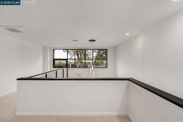 unfurnished room with light colored carpet