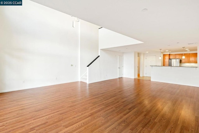 unfurnished living room with light wood-type flooring