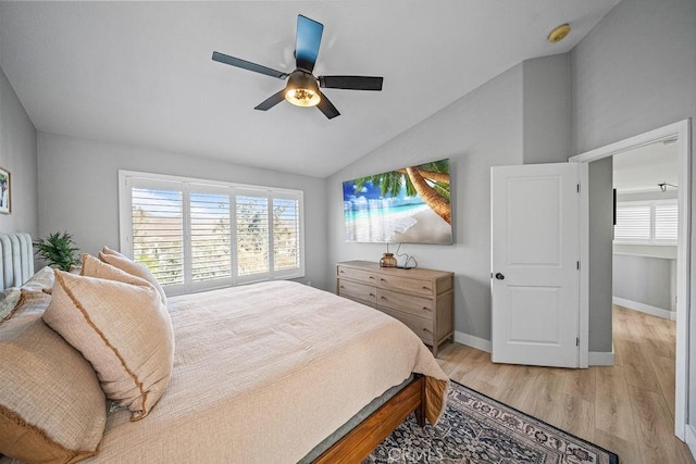 bedroom featuring ceiling fan, vaulted ceiling, and light wood-type flooring