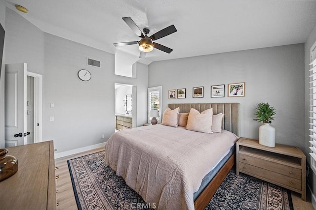 bedroom with ceiling fan, light wood-type flooring, and vaulted ceiling