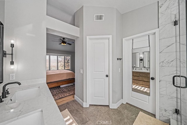 bathroom featuring an enclosed shower, ceiling fan, and vanity