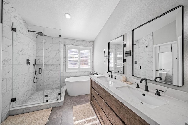 bathroom featuring a textured ceiling, vaulted ceiling, tile patterned flooring, vanity, and plus walk in shower