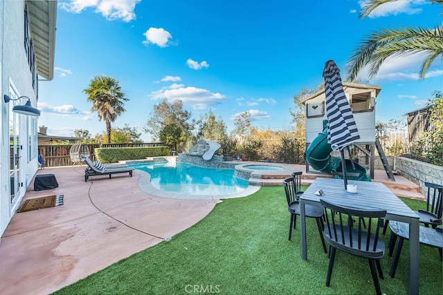 view of swimming pool with a lawn, a patio area, and an in ground hot tub