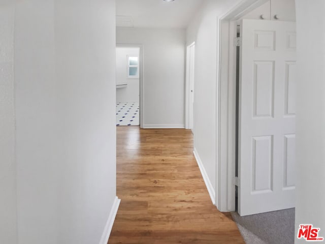 hallway with wood-type flooring