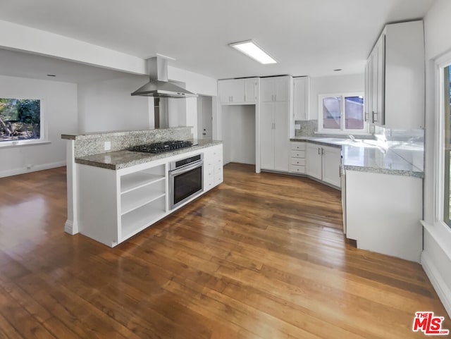 kitchen featuring light stone countertops, black gas cooktop, white cabinets, oven, and exhaust hood