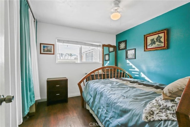 bedroom with ceiling fan and dark hardwood / wood-style flooring