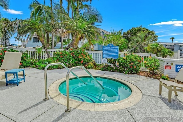 view of swimming pool featuring a patio area and a hot tub