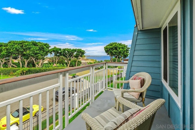 balcony featuring a water view