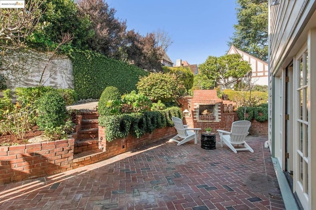 view of patio / terrace featuring an outdoor brick fireplace