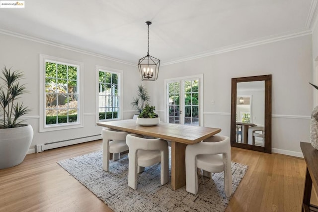 dining space with a healthy amount of sunlight, a baseboard heating unit, a notable chandelier, and light hardwood / wood-style floors