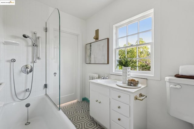 full bathroom with toilet, vanity, and  shower combination