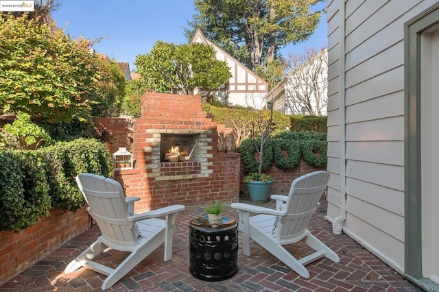 view of patio / terrace featuring an outdoor brick fireplace