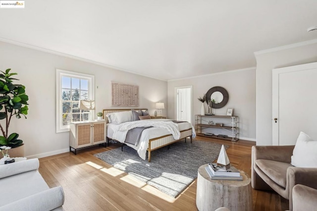 bedroom featuring crown molding and light hardwood / wood-style floors