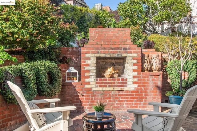 view of patio / terrace featuring an outdoor brick fireplace