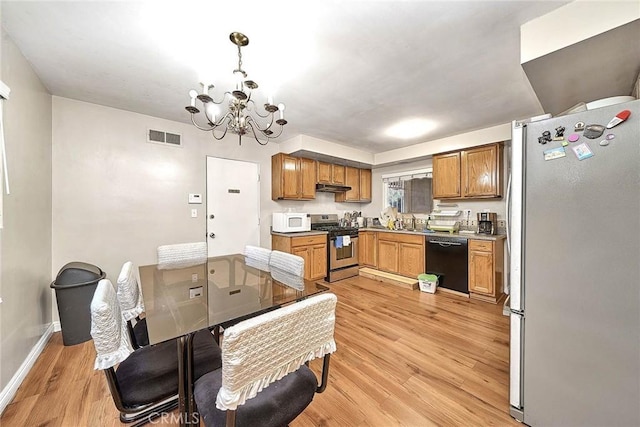kitchen with a notable chandelier, hanging light fixtures, light wood-type flooring, sink, and stainless steel appliances