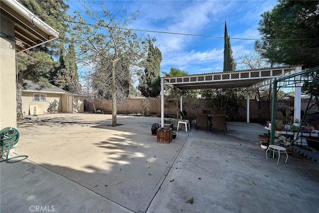 view of patio with a pergola and a shed