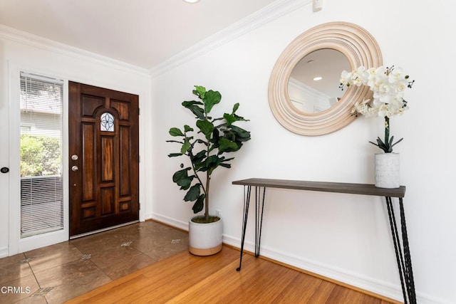 tiled foyer entrance with crown molding