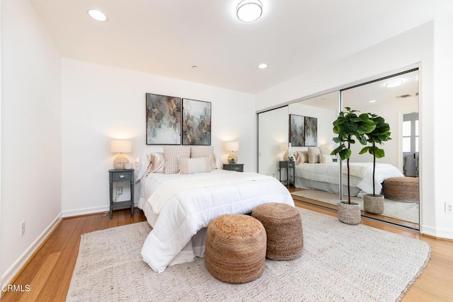 bedroom with hardwood / wood-style flooring and a closet