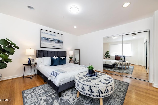 bedroom with hardwood / wood-style flooring and a closet