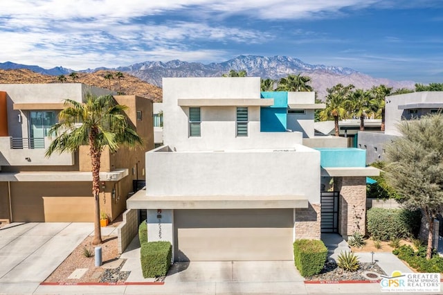 view of front facade featuring a garage and a mountain view