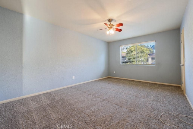 empty room with a ceiling fan, carpet, and baseboards