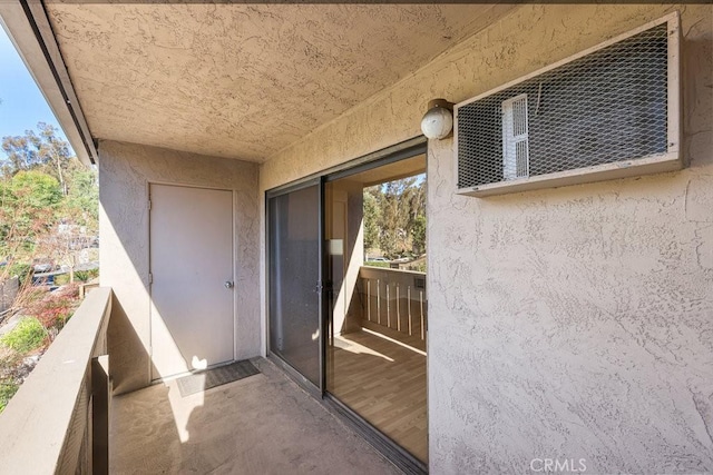 doorway to property featuring a balcony and stucco siding