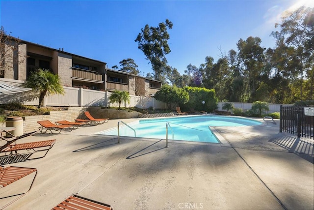 view of pool with fence, a fenced in pool, and a patio