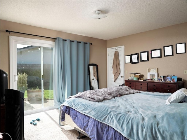 bedroom with carpet floors, access to exterior, a closet, and a textured ceiling