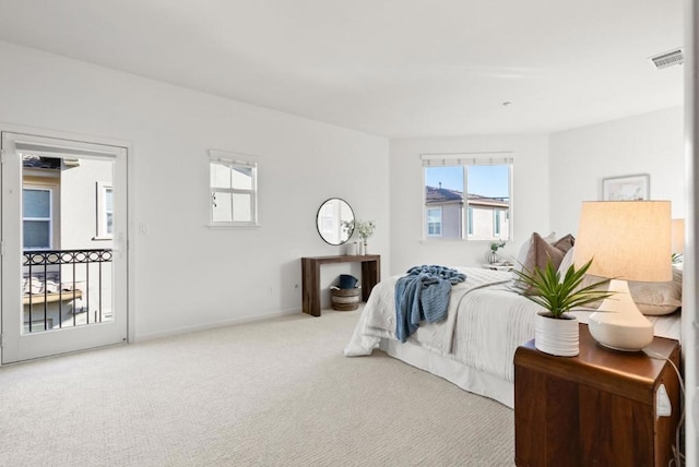 carpeted bedroom with access to outside