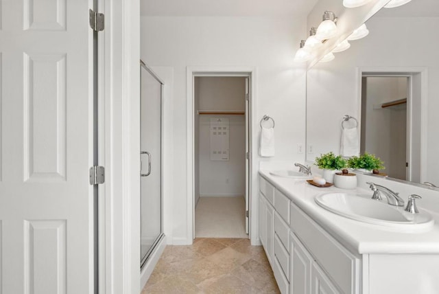 bathroom featuring an enclosed shower and vanity