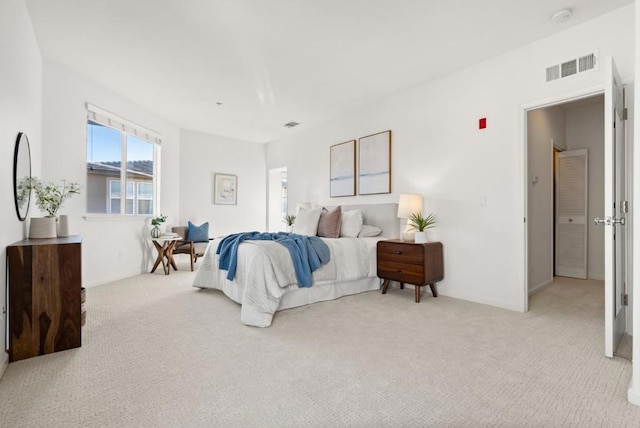 bedroom featuring light colored carpet