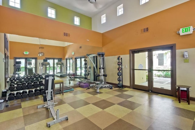 workout area with a high ceiling