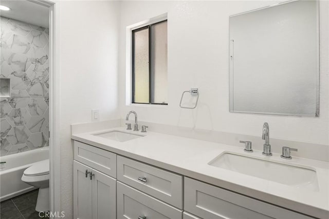 bathroom featuring a sink, toilet, double vanity, and tile patterned floors