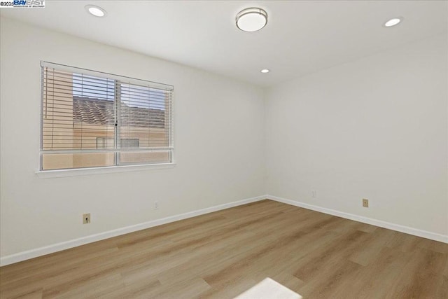 empty room with light hardwood / wood-style flooring