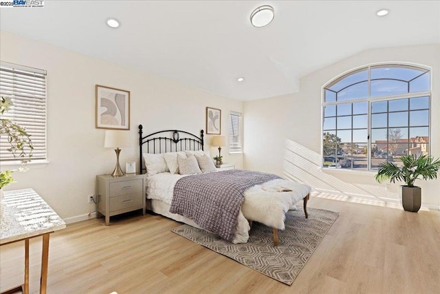 bedroom with light hardwood / wood-style flooring and vaulted ceiling