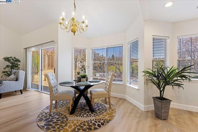 dining space with an inviting chandelier, light hardwood / wood-style flooring, and a wealth of natural light