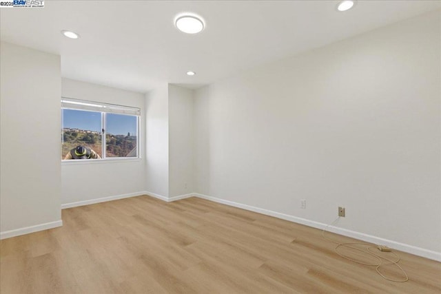 spare room with light hardwood / wood-style flooring