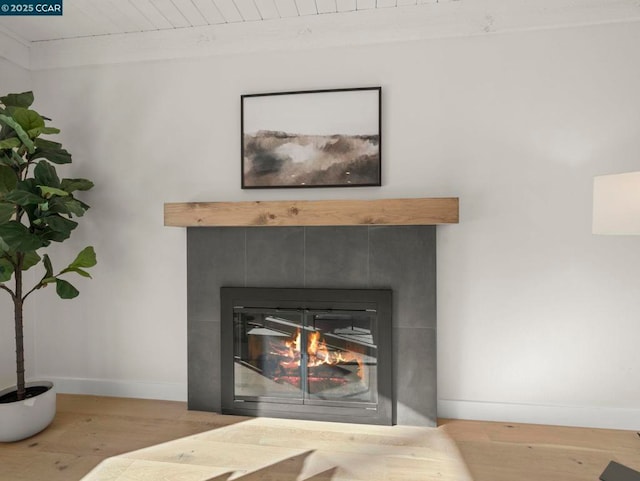 interior details featuring a fireplace and hardwood / wood-style flooring