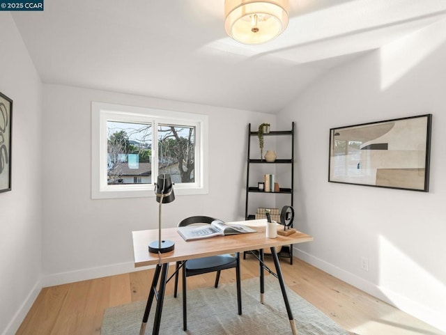 office featuring lofted ceiling and hardwood / wood-style floors