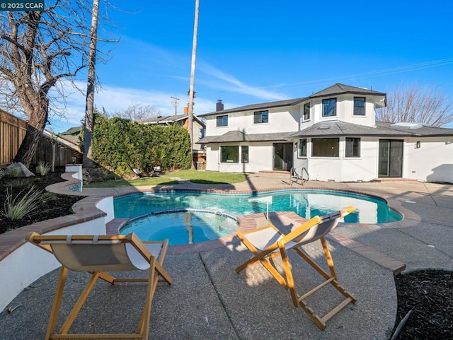 view of swimming pool featuring a patio and an in ground hot tub