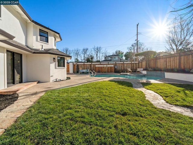 view of yard with a fenced in pool and a patio area