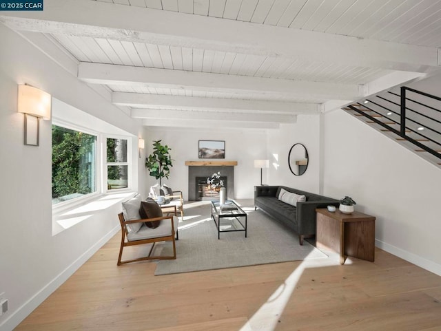 living room with light hardwood / wood-style floors and beamed ceiling