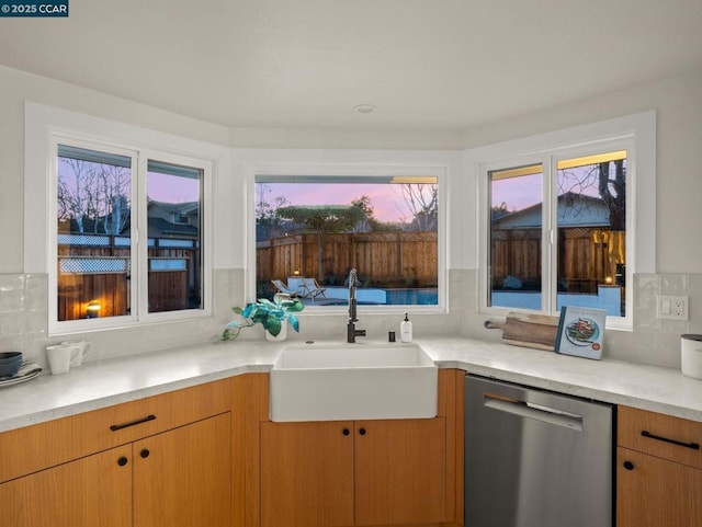 kitchen featuring dishwasher, backsplash, and sink