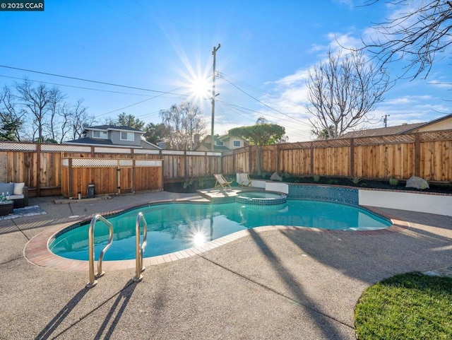 view of pool featuring a patio area and an in ground hot tub