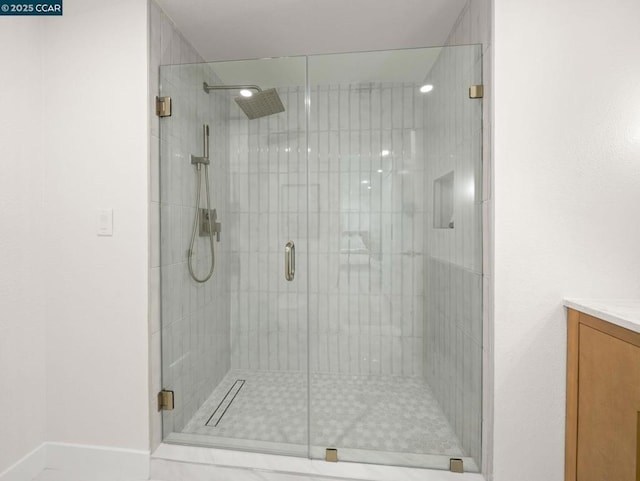 bathroom featuring a shower with door