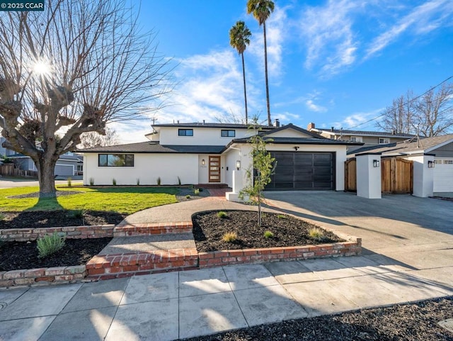 view of front of home with a front yard and a garage