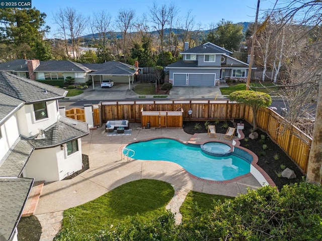 view of pool featuring an in ground hot tub, a mountain view, a patio area, a bar, and an outdoor living space