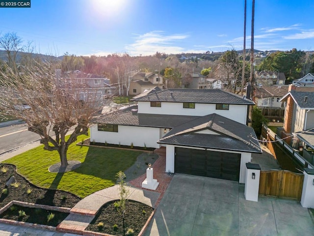 view of front of house featuring a front lawn and a garage