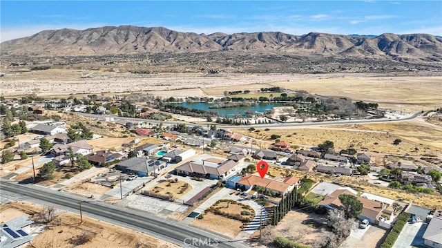 aerial view featuring a water and mountain view