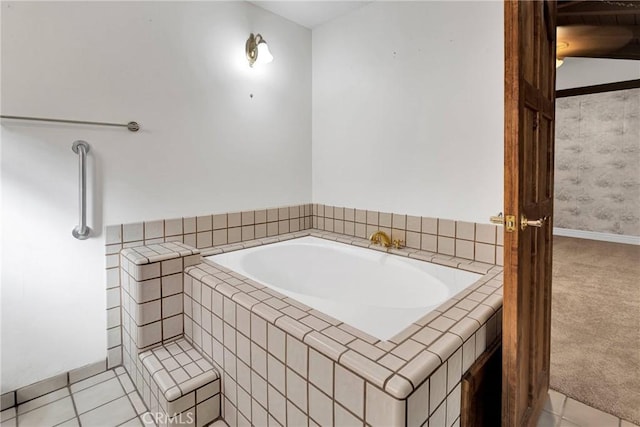 bathroom featuring tile patterned flooring and tiled tub